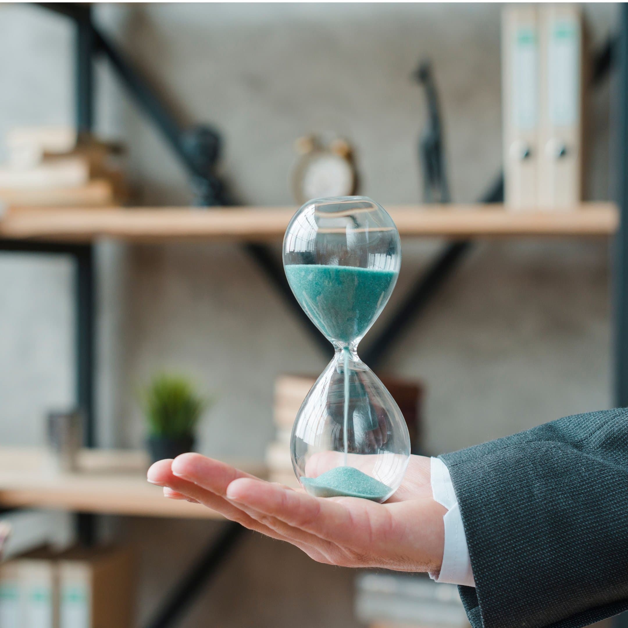 About Engage - Hand holding hourglass